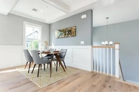 a view of a dining room with furniture window and wooden floor