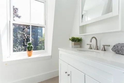 a bathroom with a sink and a window