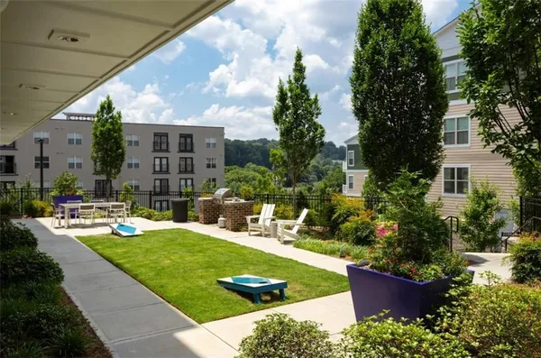 a view of a house with backyard sitting area and garden