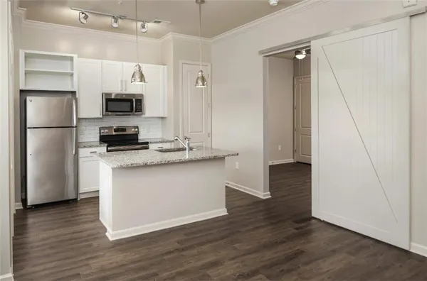 a kitchen with stainless steel appliances a refrigerator stove and microwave