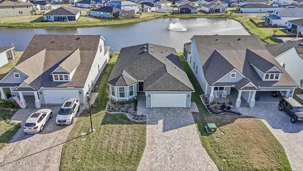 a front view of a house with a garden and yard