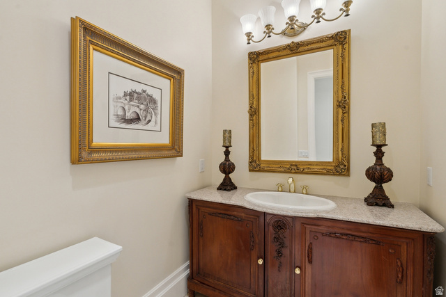 1714 Ridge Point Drive Bountiful, UT 84010 - Photo 48 of 132 Custom wood-finish vanity with an integrated sink, polished countertop, and an ornate framed mirror