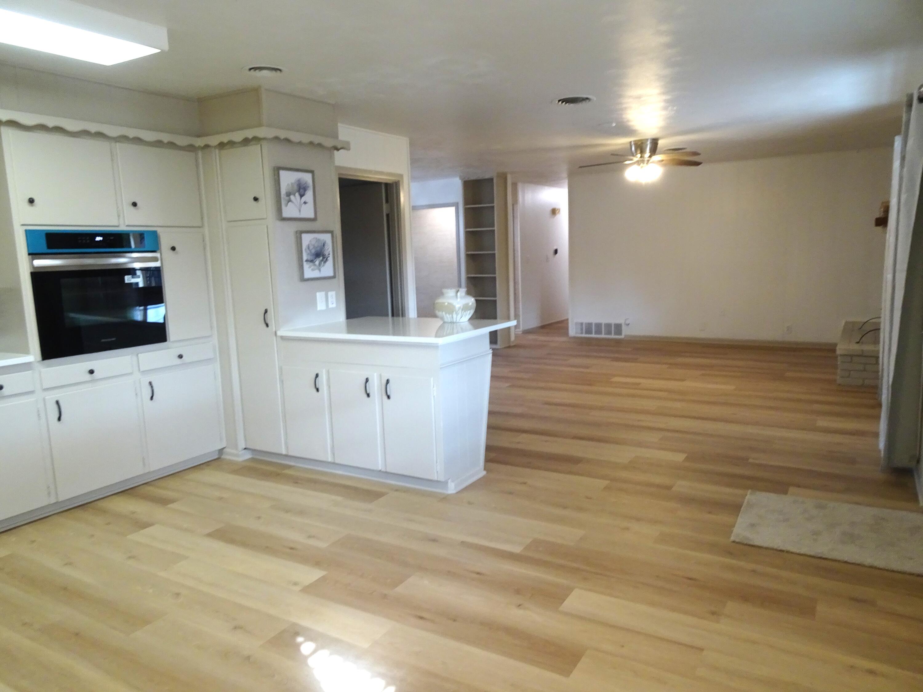 3415 58th Street Lubbock, TX 79413 - Photo 21 of 40 a view of a kitchen with microwave and cabinets