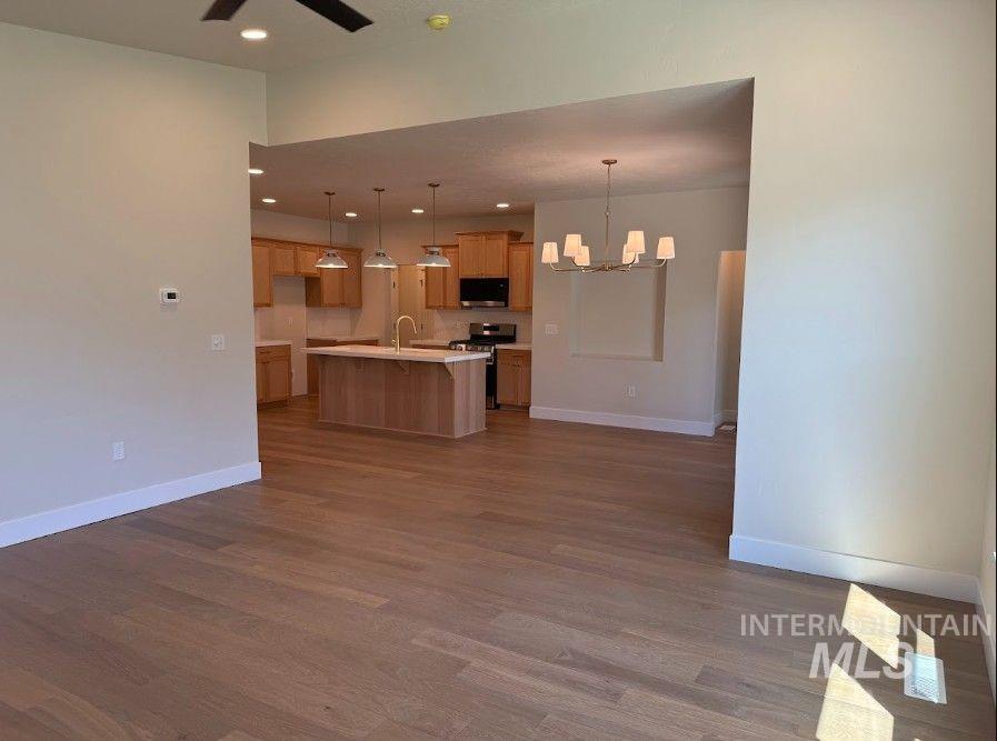 683 West Wrangler Street Meridian, ID 83646 - Photo 7 of 23 Expansive wood-finish flooring extends throughout the main living areas