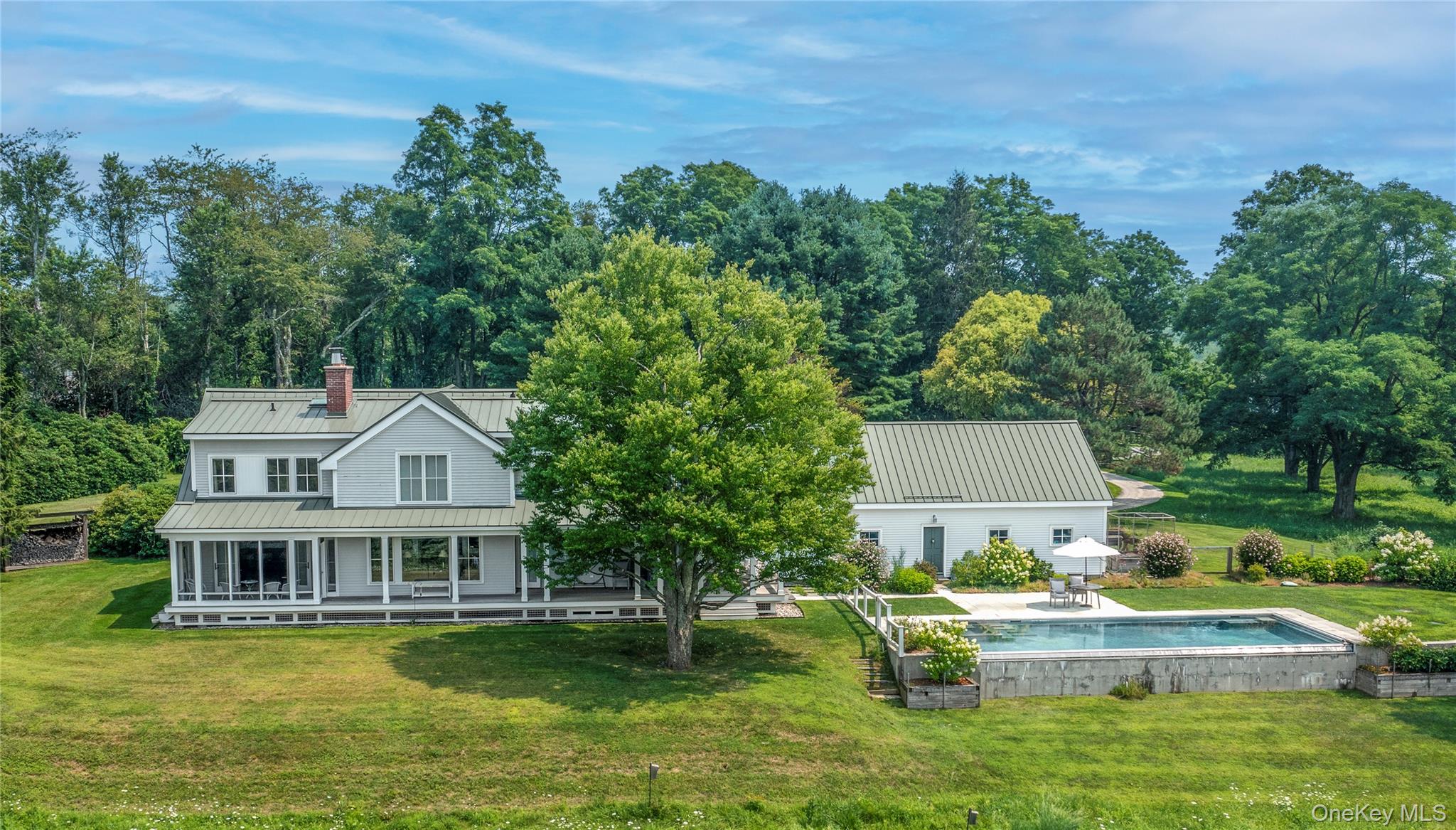 34 Meeting House Road Pawling, NY 12564 - Photo 2 of 44 a front view of a house with a garden and swimming pool