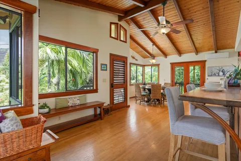 a living room filled with furniture and a wooden floor