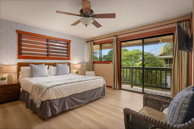 a bedroom with a large bed and a large window