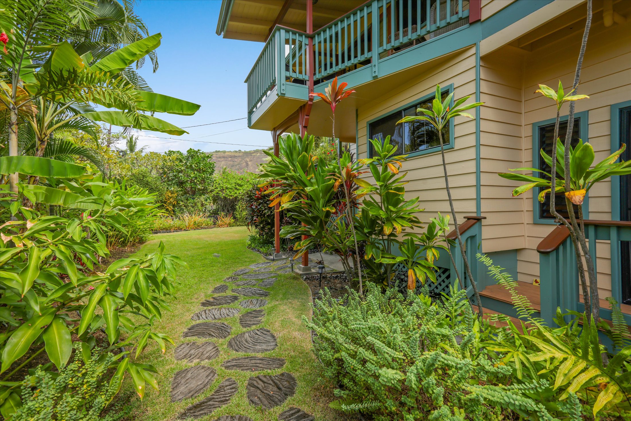 82-6289 Kahauloa Road Captain Cook, HI 96704 - Photo 3 of 29 a backyard of a house with a garden and outdoor seating