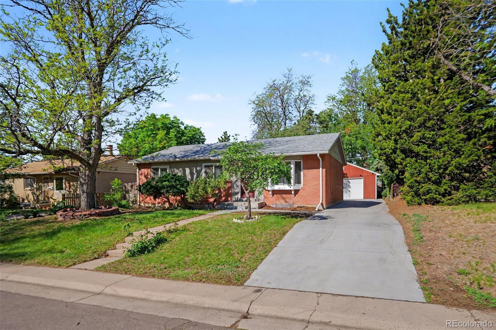 3217 South Stuart Street Denver, CO 80236 - Photo 2 of 29 a front view of a house with a yard