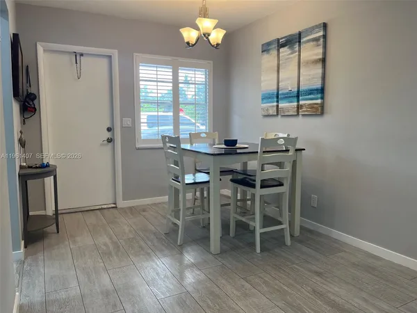 a view of a dining room with furniture and a window