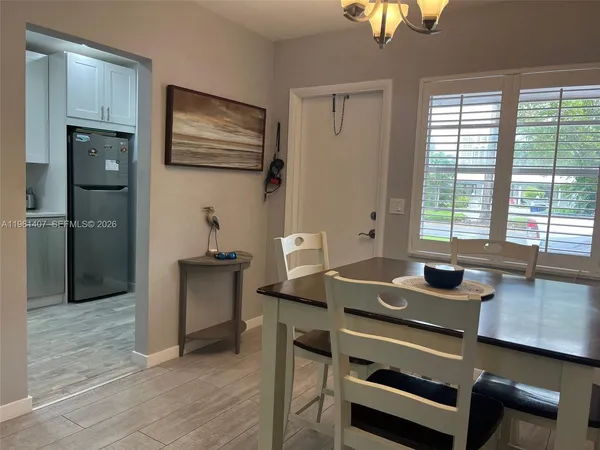 a view of a workspace with furniture and window