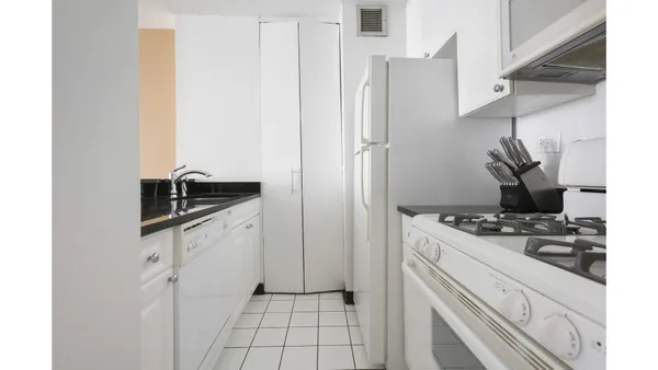 a kitchen with stainless steel appliances granite countertop a refrigerator and a stove