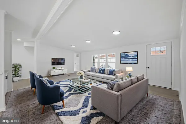 a living room with furniture a couch and a flat screen tv
