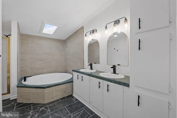 a bathroom with a bathtub and a shower