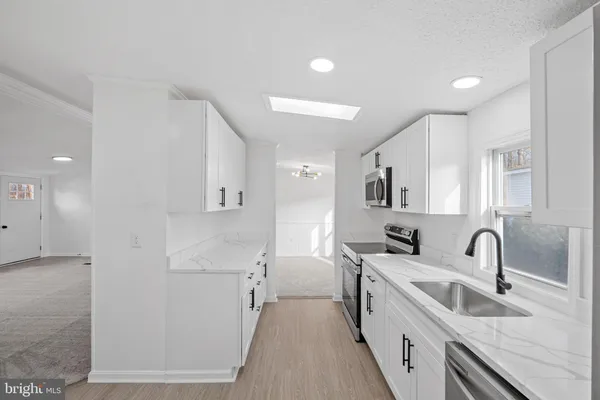 a kitchen with sink a faucet and appliances