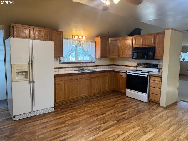 a kitchen with stainless steel appliances a stove a sink and a refrigerator