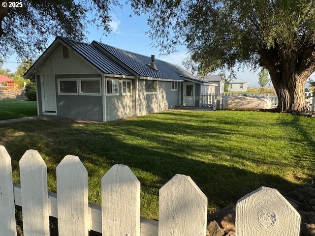 1645 4th Street Haines, OR 97833 - Photo 2 of 26 a front view of a house with a garden
