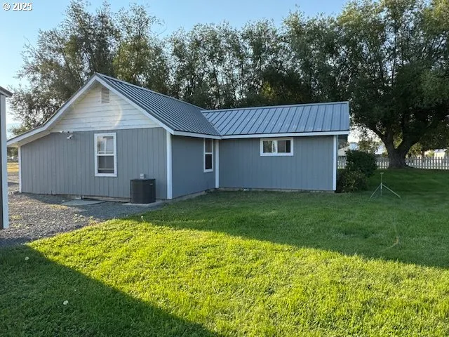 a view of backyard of house with green space