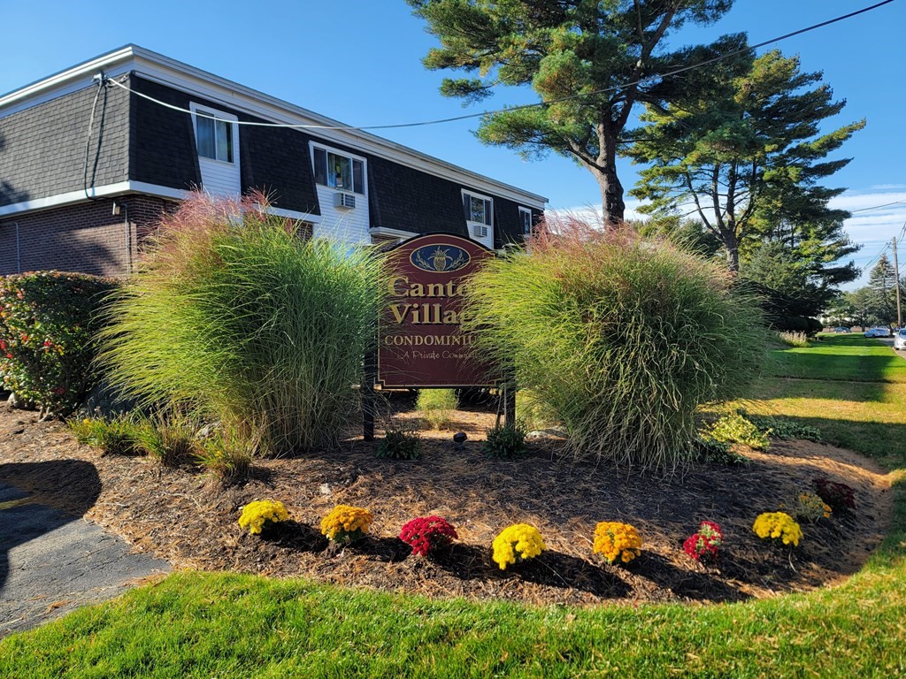 a backyard of a house with swimming pool and outdoor seating