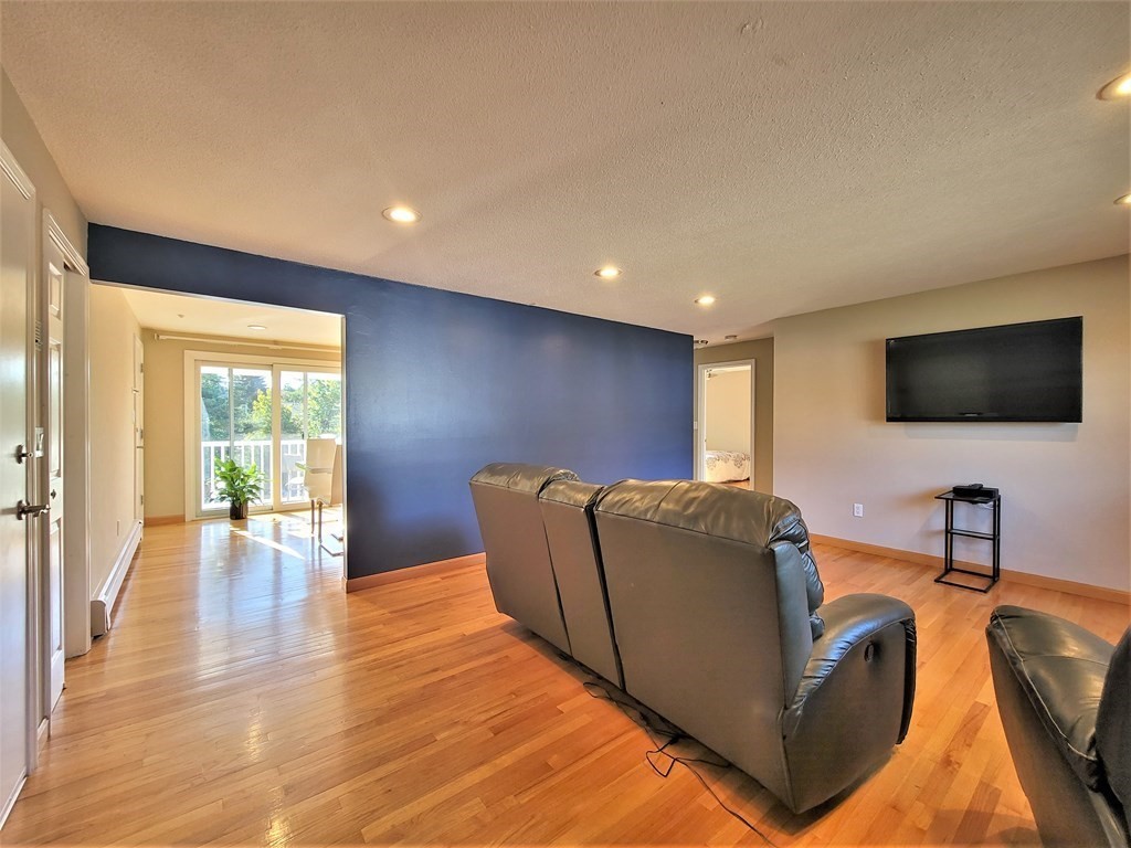 38 Will Drive, Unit 42 Canton, MA 02021 - Photo 11 of 25 a living room with furniture and a flat screen tv