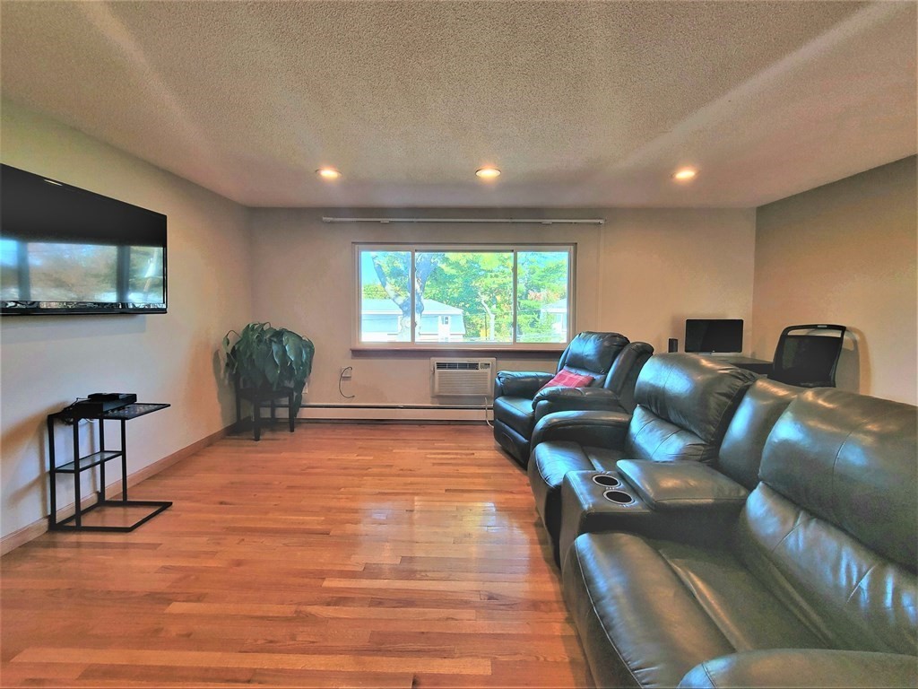 38 Will Drive, Unit 42 Canton, MA 02021 - Photo 13 of 25 a living room with furniture and a flat screen tv