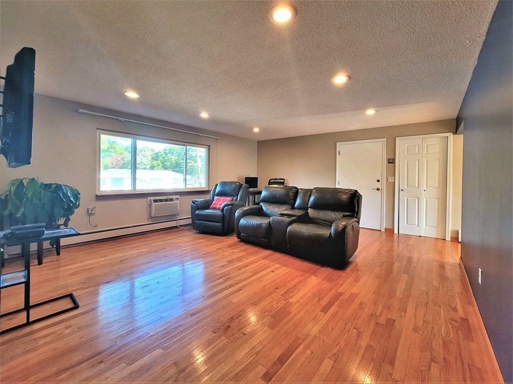38 Will Drive, Unit 42 Canton, MA 02021 - Photo 14 of 25 a living room with furniture and a wooden floor