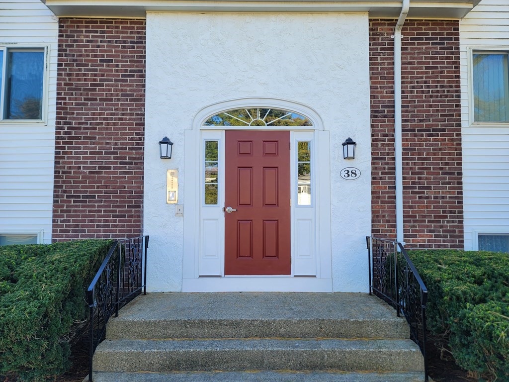 38 Will Drive, Unit 42 Canton, MA 02021 - Photo 2 of 25 a front view of a house with a garden