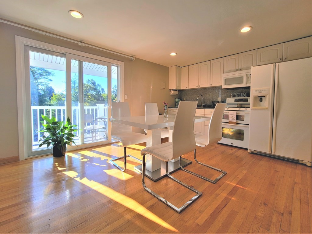 38 Will Drive, Unit 42 Canton, MA 02021 - Photo 4 of 25 a view of a kitchen with furniture a potted plant and wooden floor