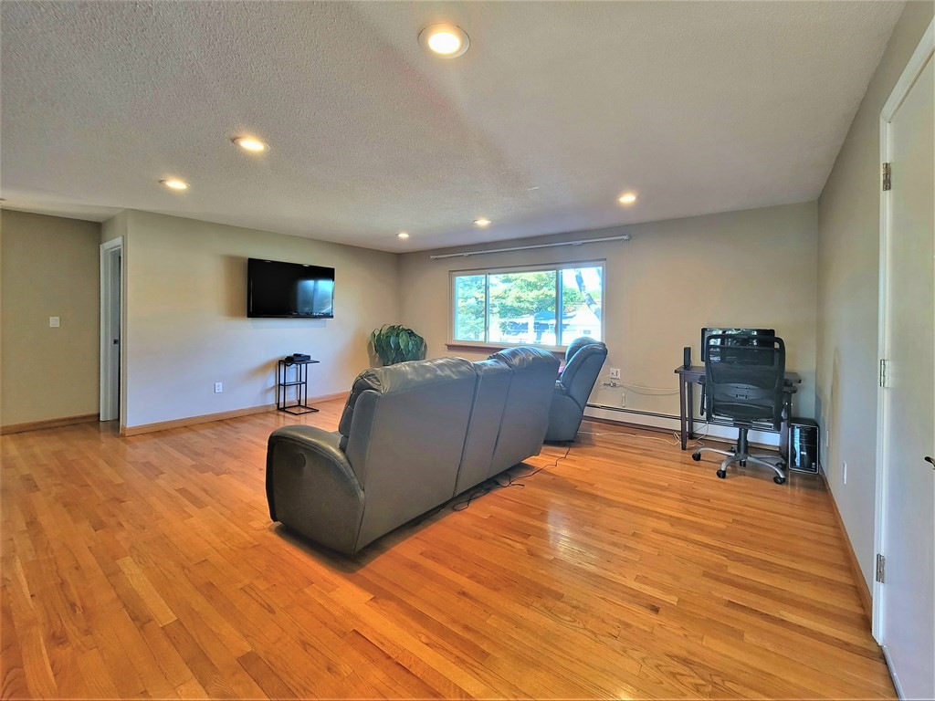 38 Will Drive, Unit 42 Canton, MA 02021 - Photo 10 of 25 a living room with furniture and a flat screen tv
