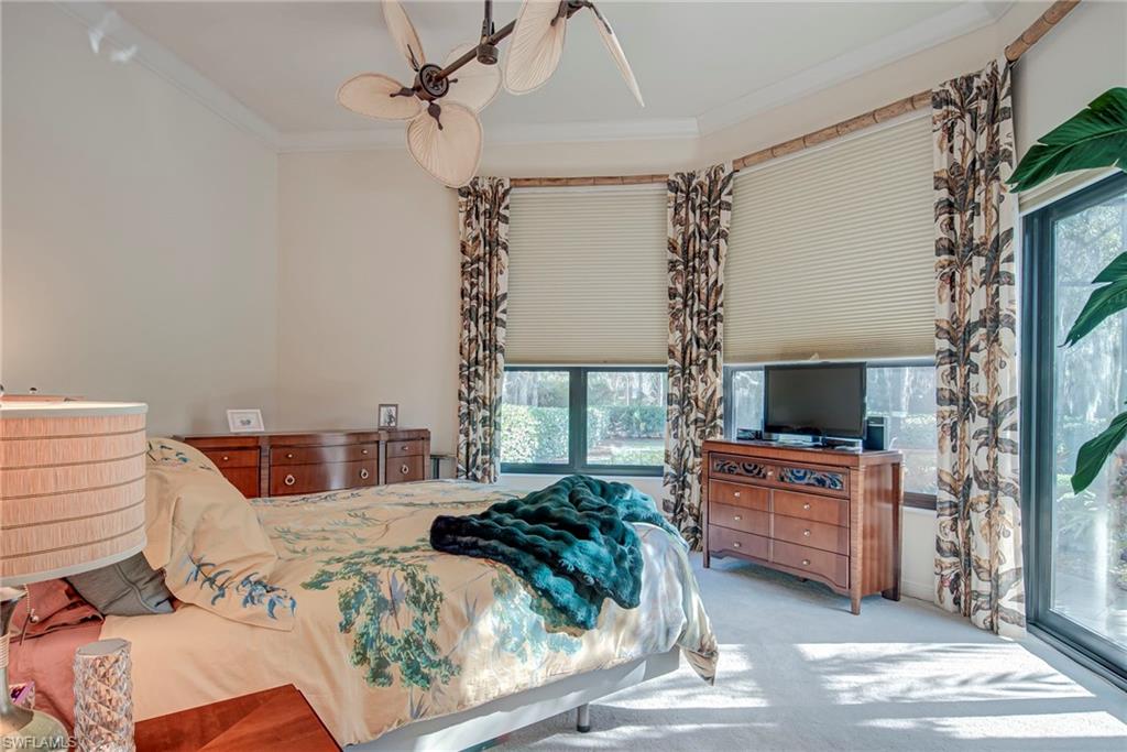 3126 Terramar Court Naples, FL 34119 - Photo 15 of 31 a bedroom with a large bed and a flat tv screen on dresser