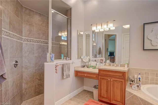 a bathroom with double vanity sinks a toilet a mirror and shower