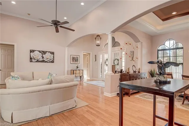 a living room with furniture a two couches and a chandelier