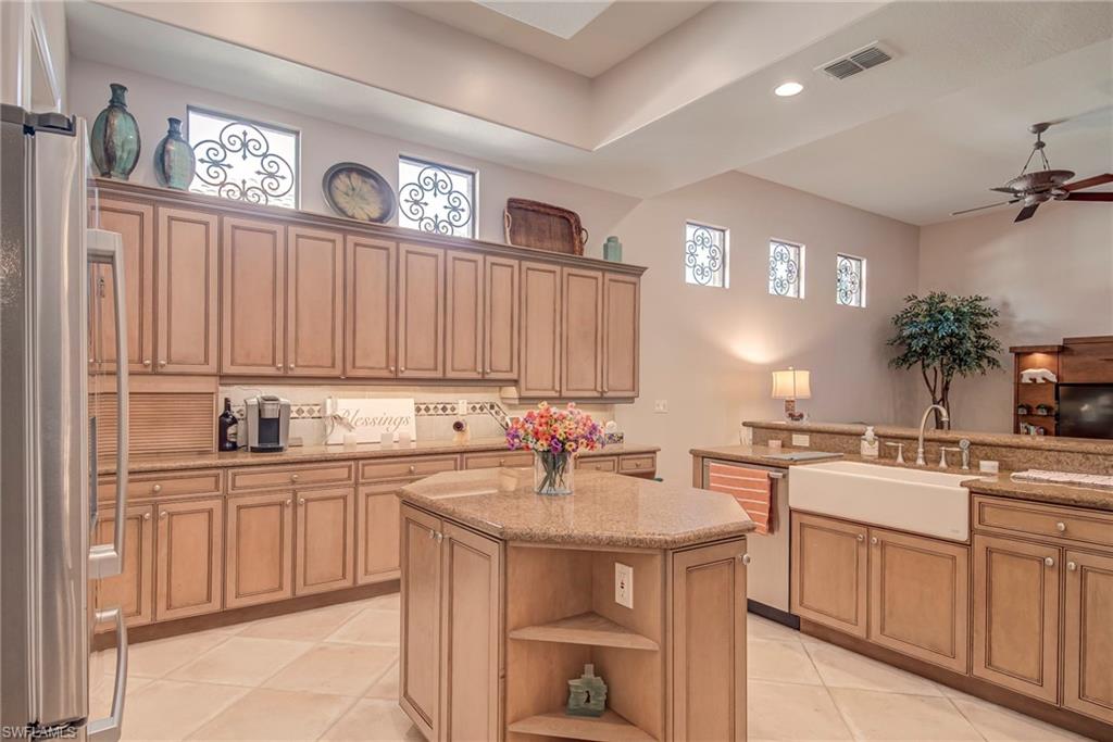 3126 Terramar Court Naples, FL 34119 - Photo 8 of 31 a kitchen with a sink stove and cabinets