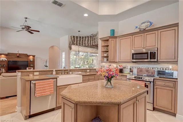 a kitchen with stainless steel appliances granite countertop a sink stove and cabinets