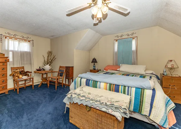 a bedroom with furniture and a large window