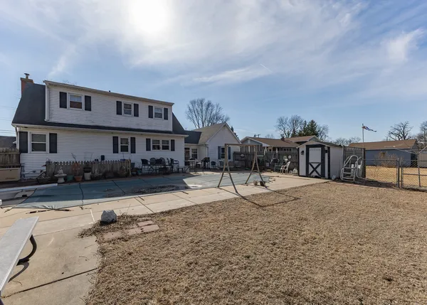 a house view with a swimming pool and sitting area