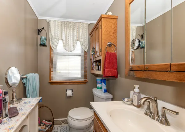 a bathroom with a sink a toilet and a mirror