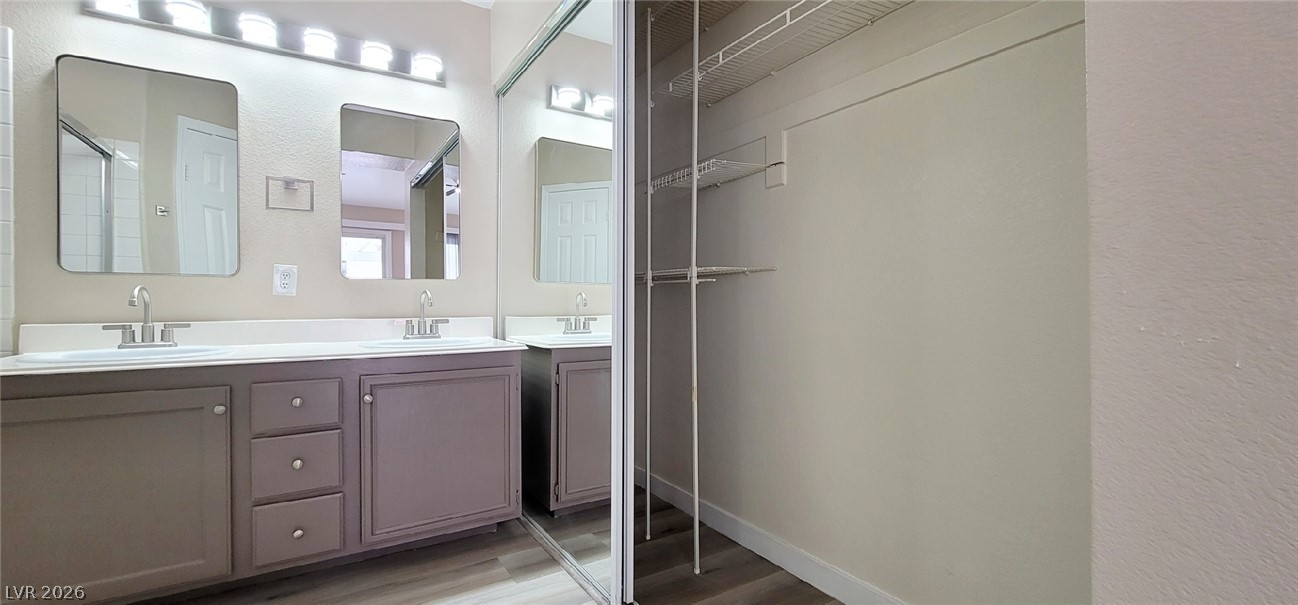 19 Rue De Parc Henderson, NV 89074 - Photo 10 of 23 A spacious double vanity stands directly adjacent to a functional walk-in closet space.