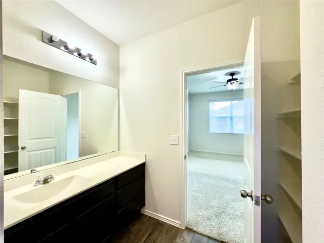 a bathroom with a double vanity sink a mirror and a shower