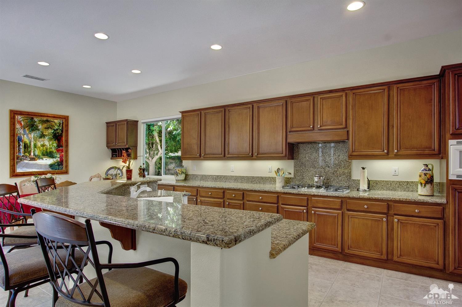 388 Loch Lomond Road Rancho Mirage, CA 92270 - Photo 16 of 41 a kitchen with granite countertop a sink and cabinets