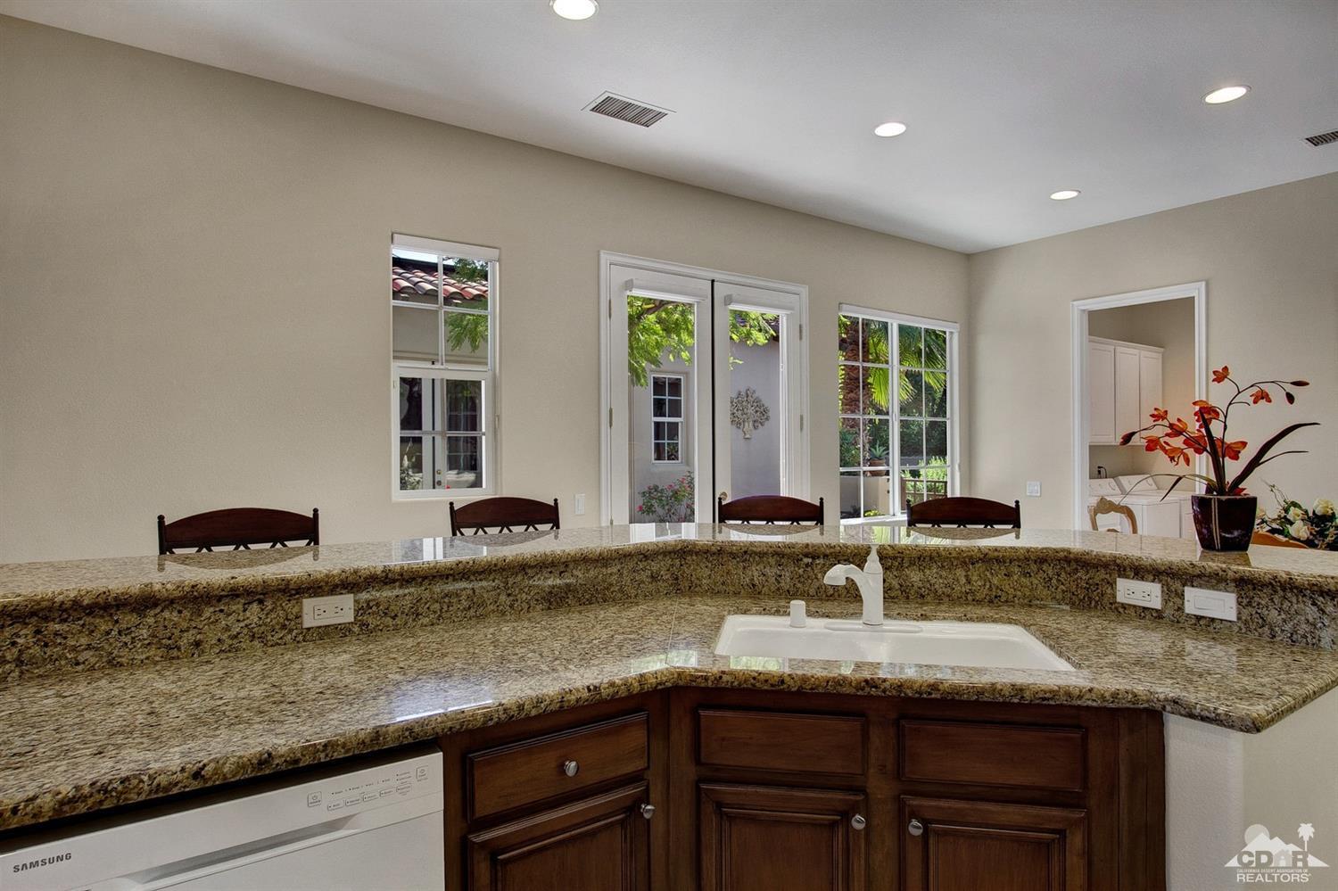 388 Loch Lomond Road Rancho Mirage, CA 92270 - Photo 18 of 41 a kitchen with granite countertop a sink and a window
