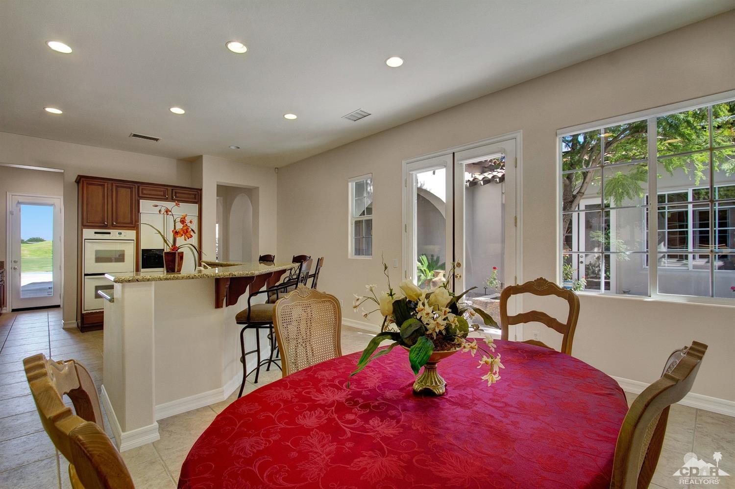 388 Loch Lomond Road Rancho Mirage, CA 92270 - Photo 20 of 41 a view of a dining room with furniture and a large window