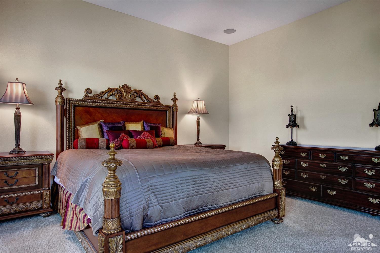 388 Loch Lomond Road Rancho Mirage, CA 92270 - Photo 25 of 41 a bedroom with a bed and a chandelier