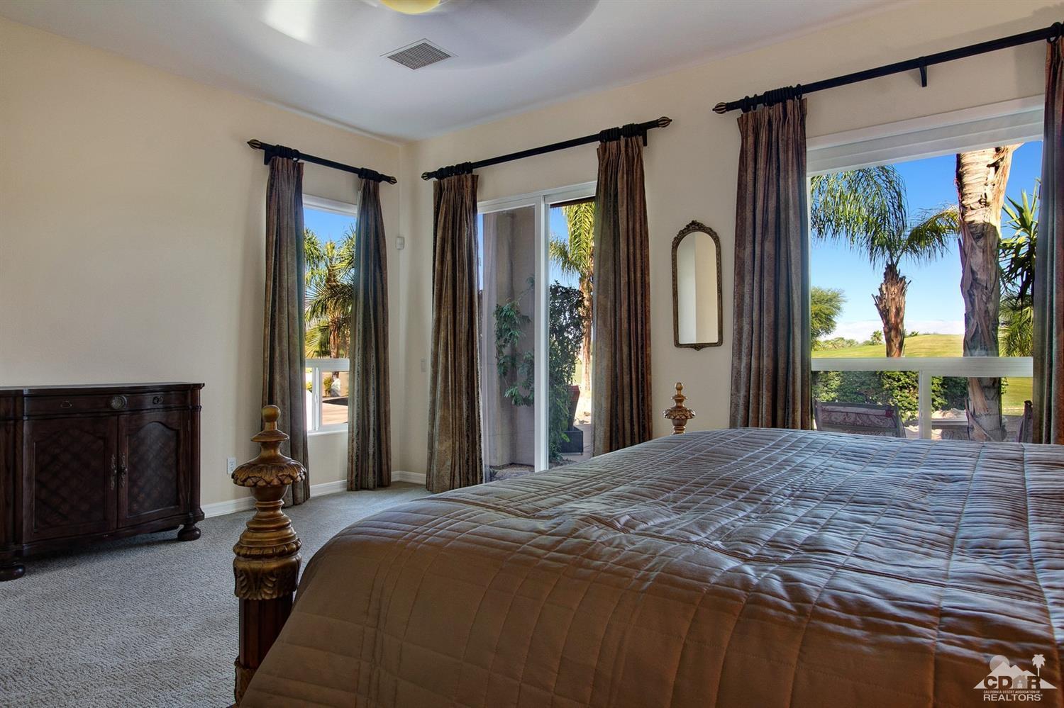 388 Loch Lomond Road Rancho Mirage, CA 92270 - Photo 26 of 41 a bedroom with a bed and a large window