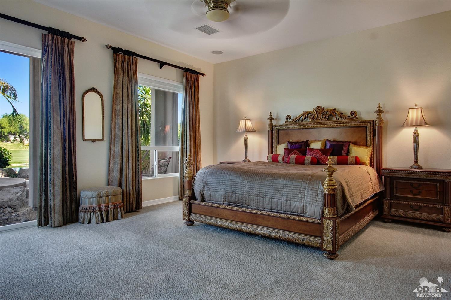 388 Loch Lomond Road Rancho Mirage, CA 92270 - Photo 27 of 41 a bedroom with a bed and a chandelier
