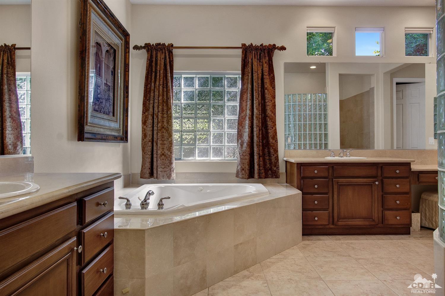 388 Loch Lomond Road Rancho Mirage, CA 92270 - Photo 31 of 41 a spacious bathroom with a tub sink and mirror