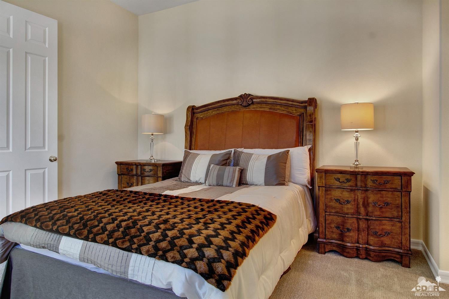 388 Loch Lomond Road Rancho Mirage, CA 92270 - Photo 32 of 41 a bedroom with a bed and dresser