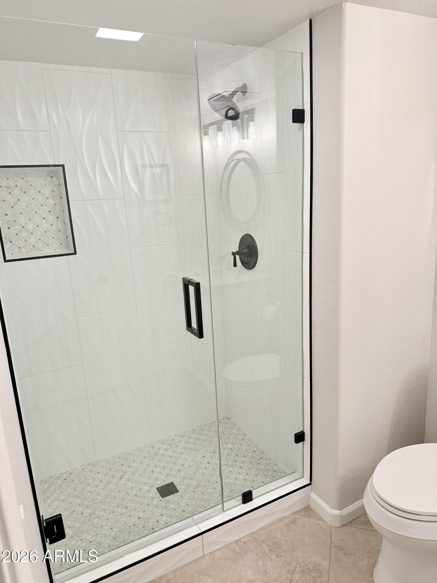 3426 East Clark Road Phoenix, AZ 85050 - Photo 9 of 48 a bathroom with a shower and toilet