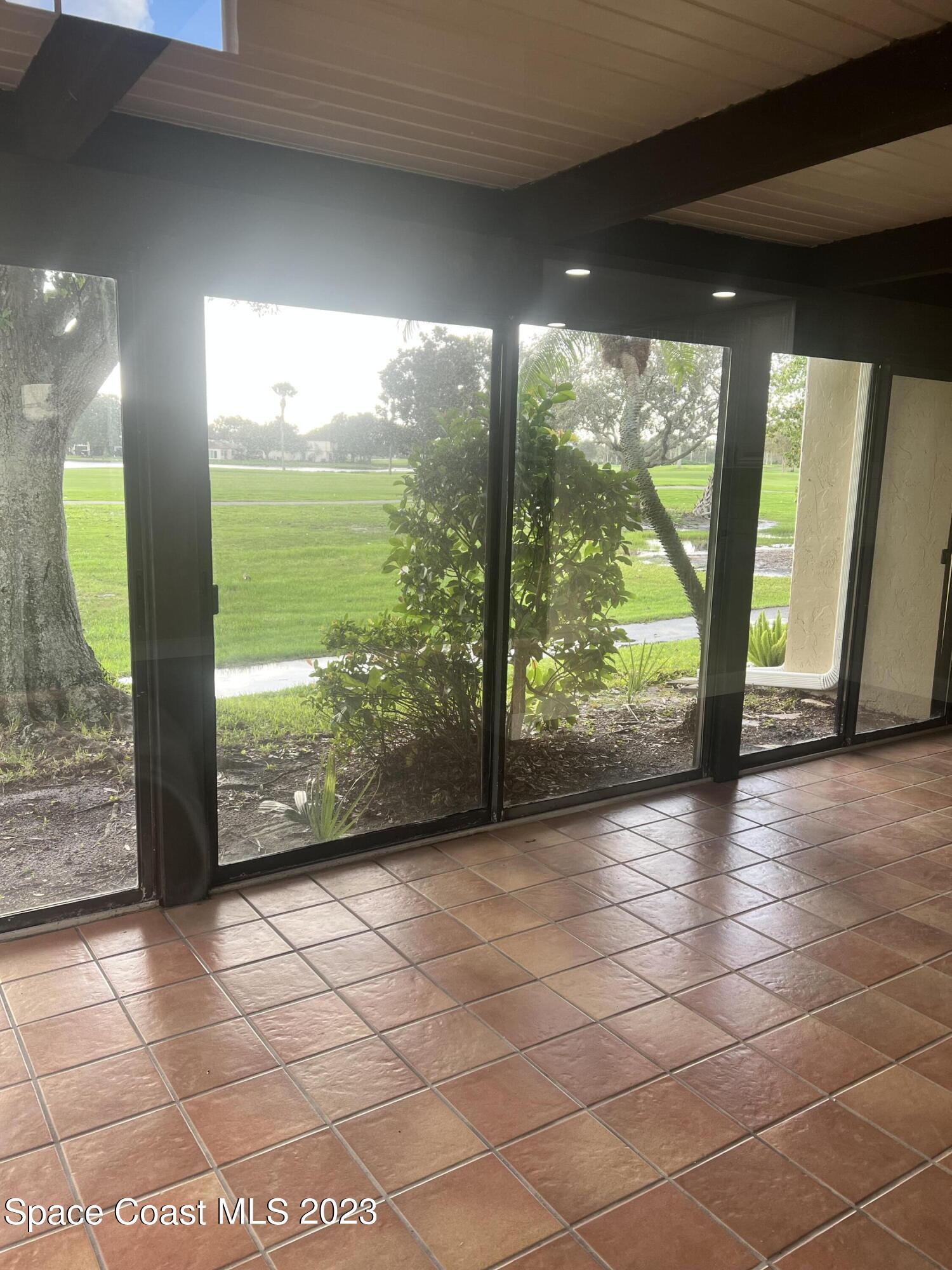 161 Augusta Way Melbourne, FL 32940 - Photo 11 of 26 a view of a room with wooden floor and outdoor space