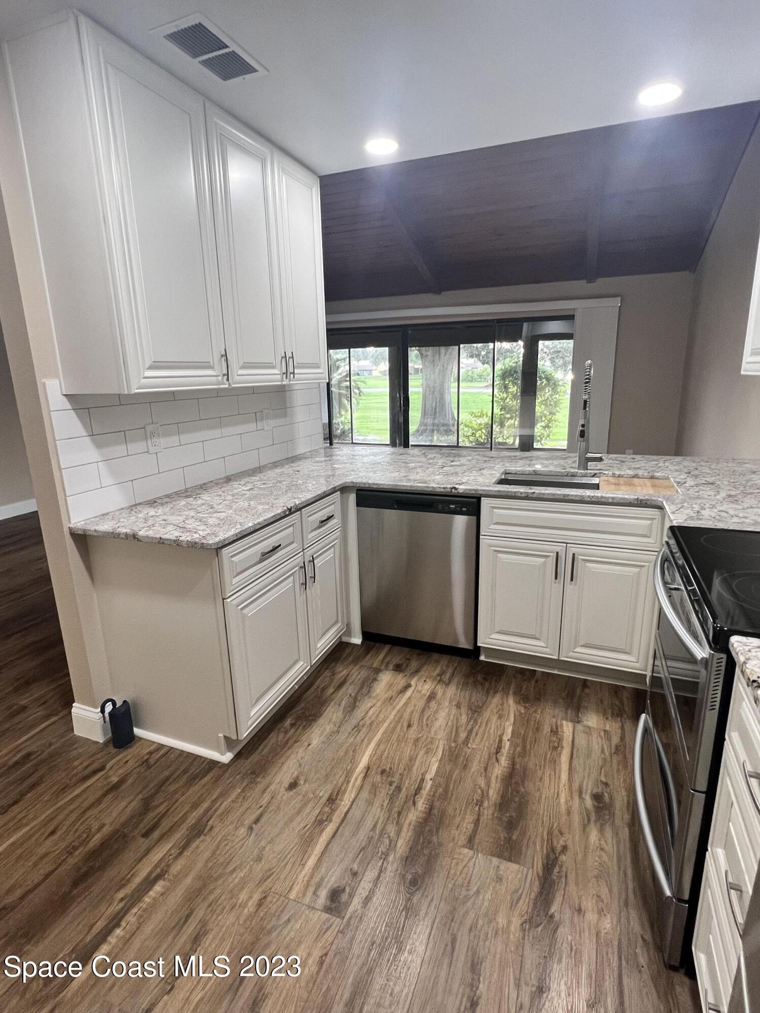 161 Augusta Way Melbourne, FL 32940 - Photo 15 of 26 a kitchen with a sink window and cabinets